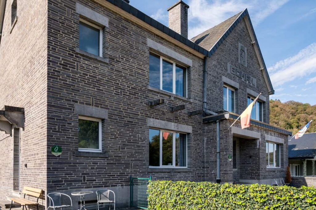 An old custom house with the flag of belgium and france