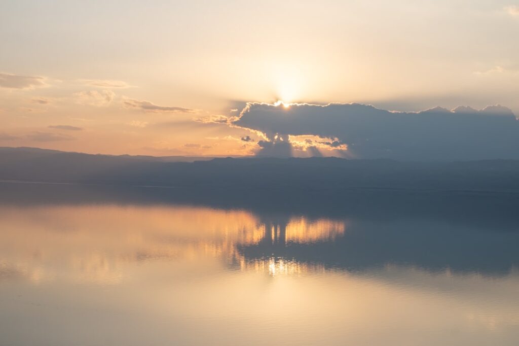sunset over the dead sea with clouds and mirror