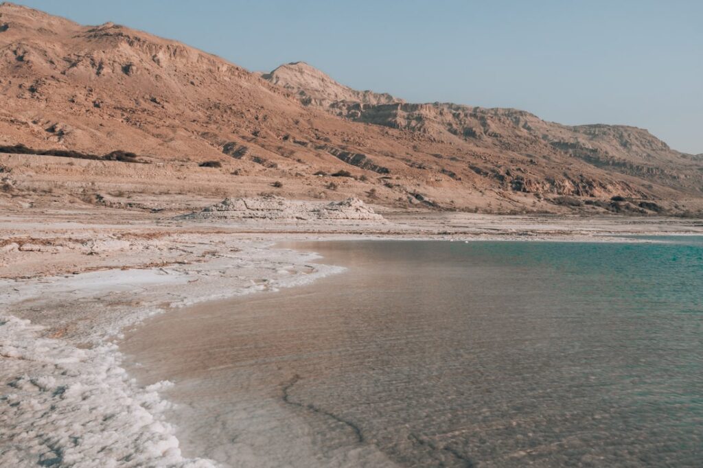 dead sea shore with salt and mountains