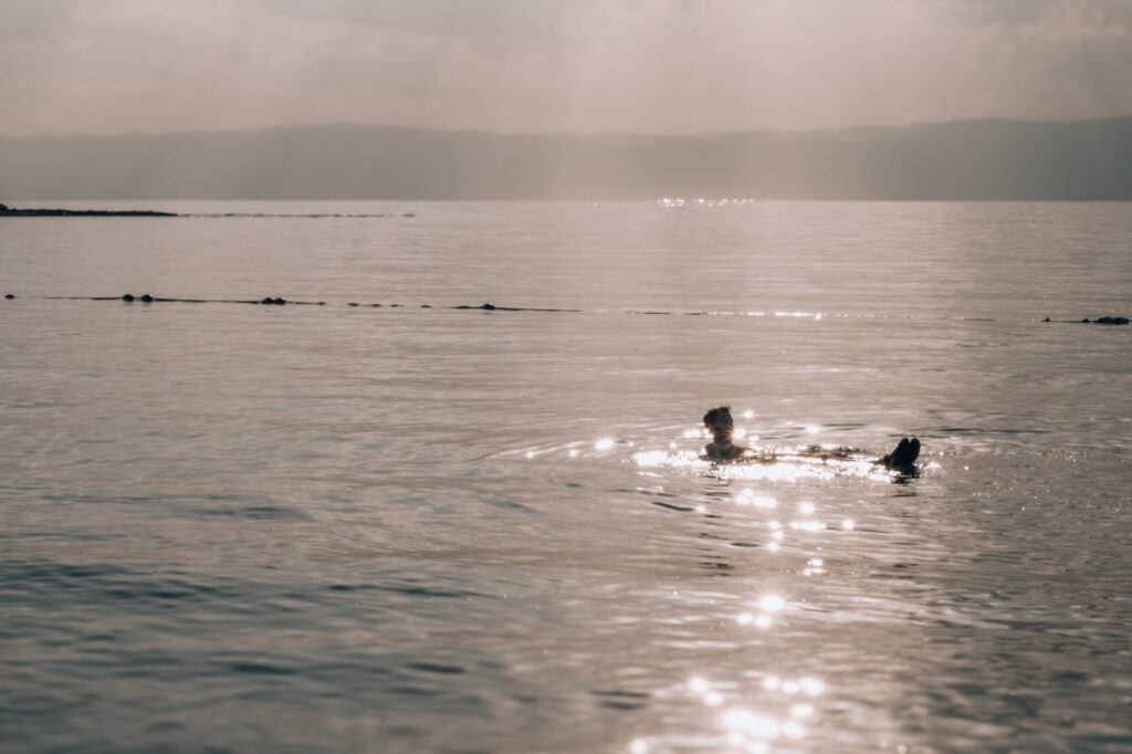 matthias floating in dead sea with sun rays
