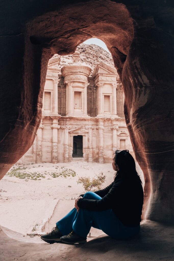 mieke inside cave with a view over monastery in petra jordan