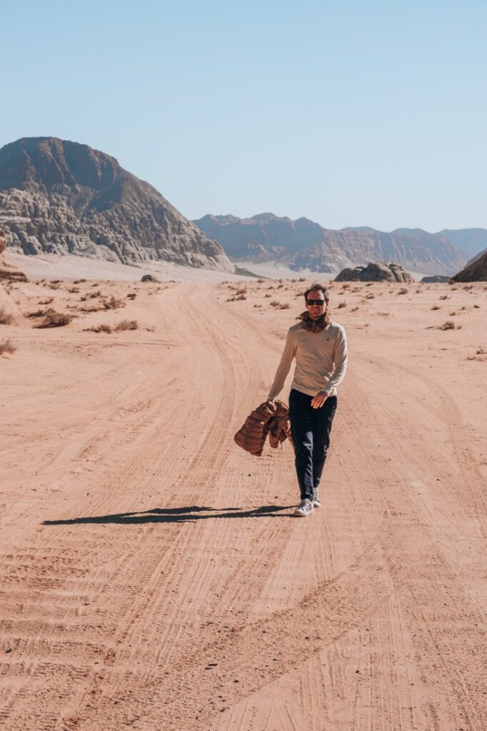 Matthias walking on dusty road in wadi rum