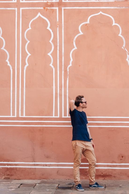 matthias standing in front of pink wall in the city palace in jaipur