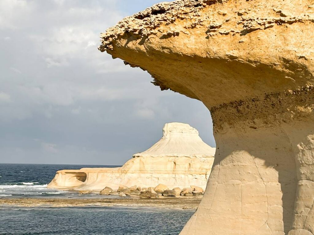swejni rock on gozo, framed by a similar rock structure