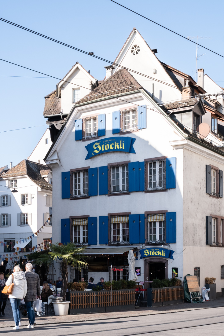 A typical house in Basel, with colorful blue window blinds