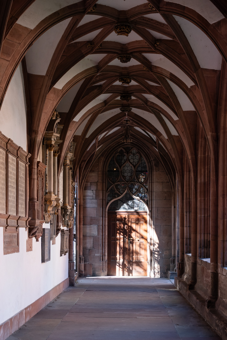 Hallway with arches in the Minster of Basel, where the light drops many shadows