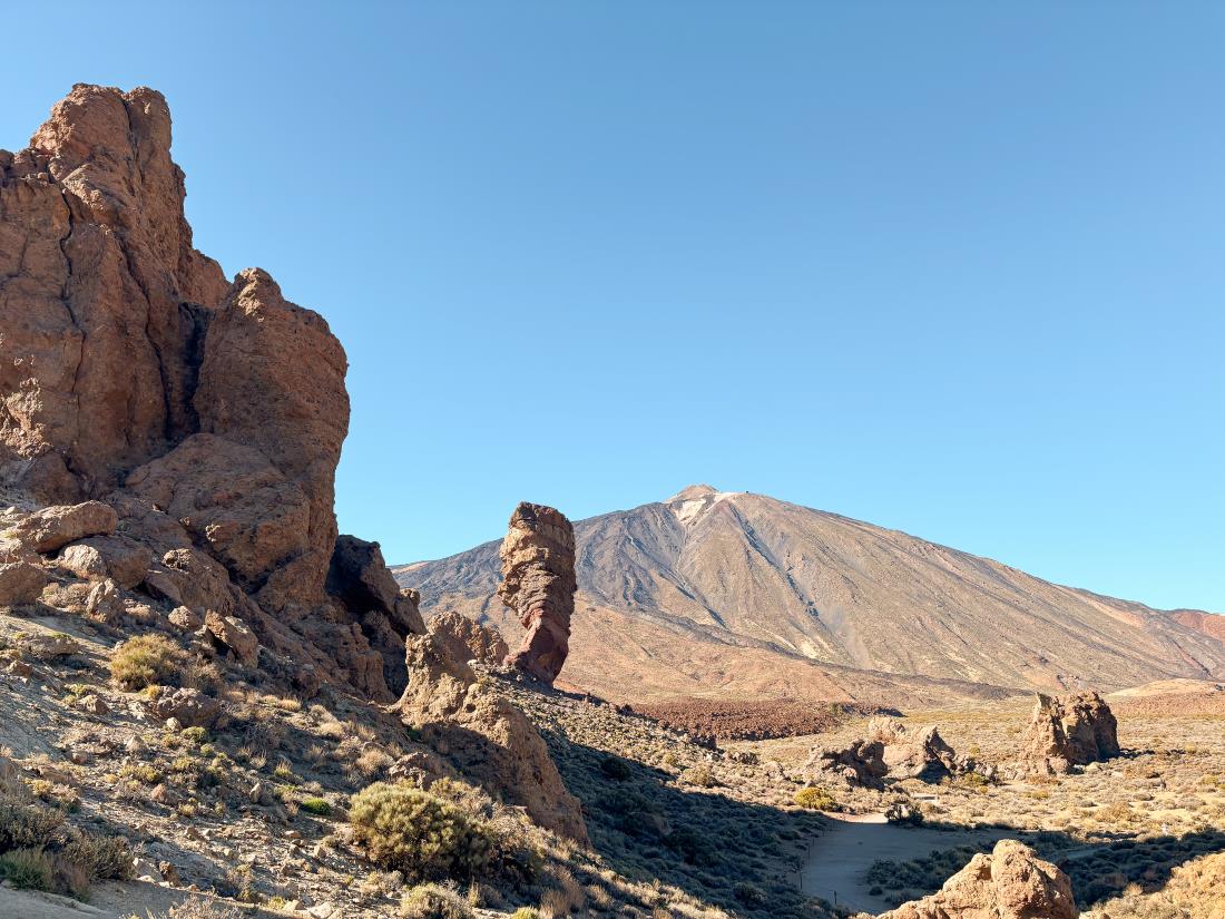 landscape at Teide national park, with rock formations in the front and the Teide volcano in the back