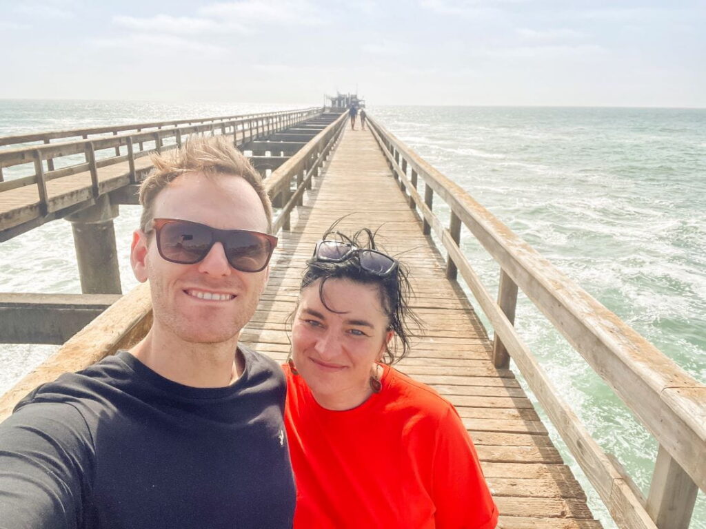 Mieke and Matthias, taking a selfie on the wooden jetty extending over the sea in Swakopmund in Namibia